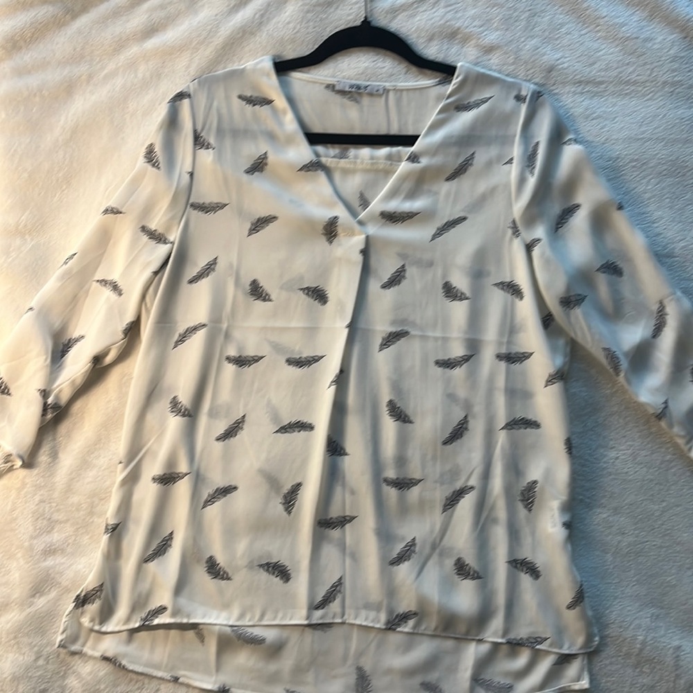 White blouse with feather details